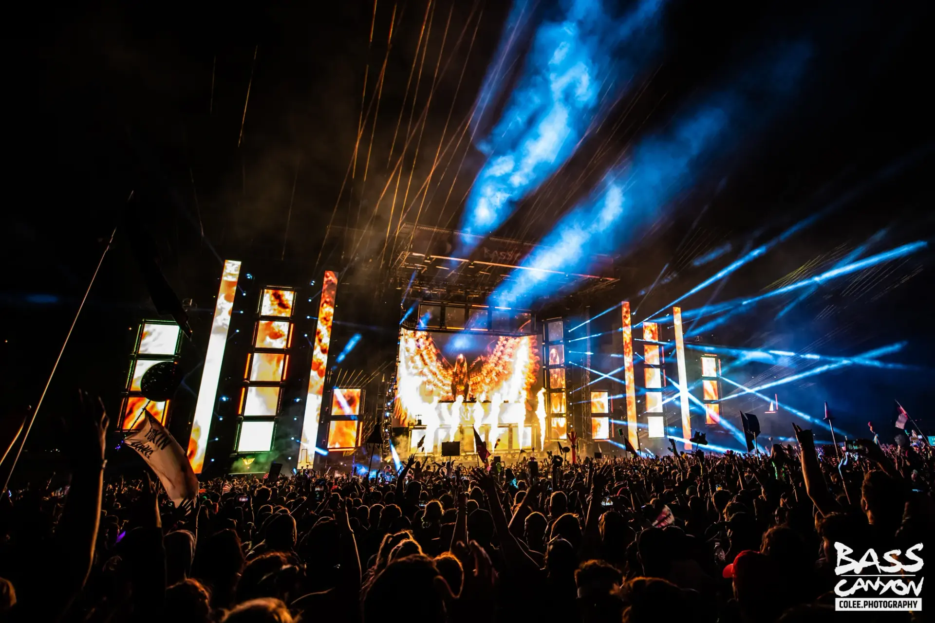 Blue smoke trails above bright stage panels and a packed nighttime crowd, Bass Canyon 2021 at The Gorge Amphitheatre, George, Washington