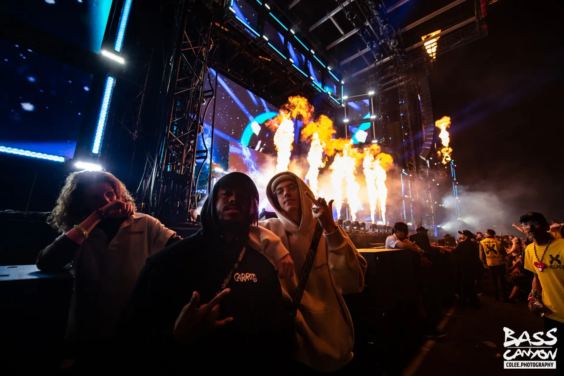 Festivalgoers posing beside the stage with tall flames behind them, Bass Canyon 2021 at The Gorge Amphitheatre, George, Washington