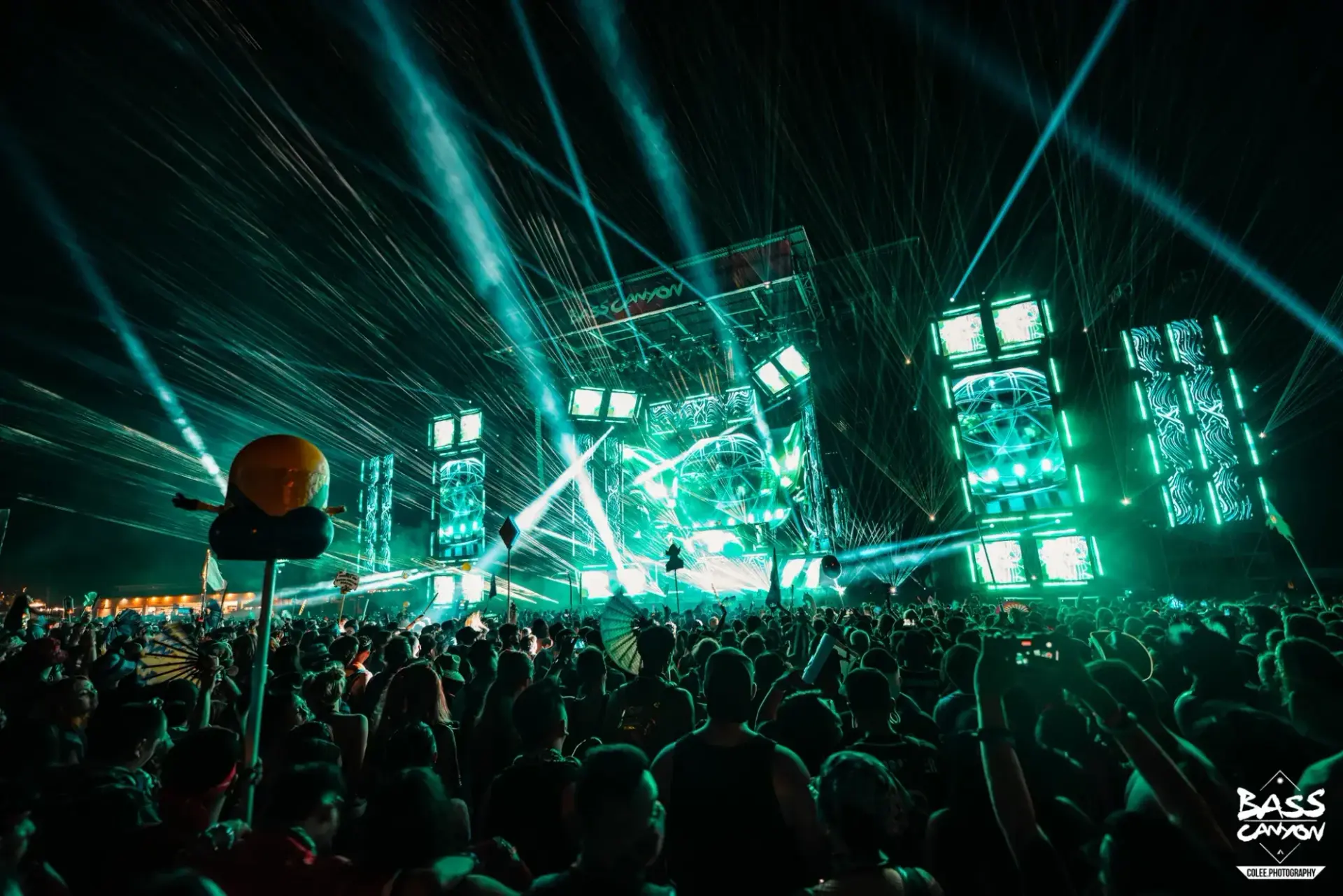 Audience beneath intersecting turquoise beams and green stage panels, Bass Canyon 2022 at The Gorge Amphitheatre, George, Washington
