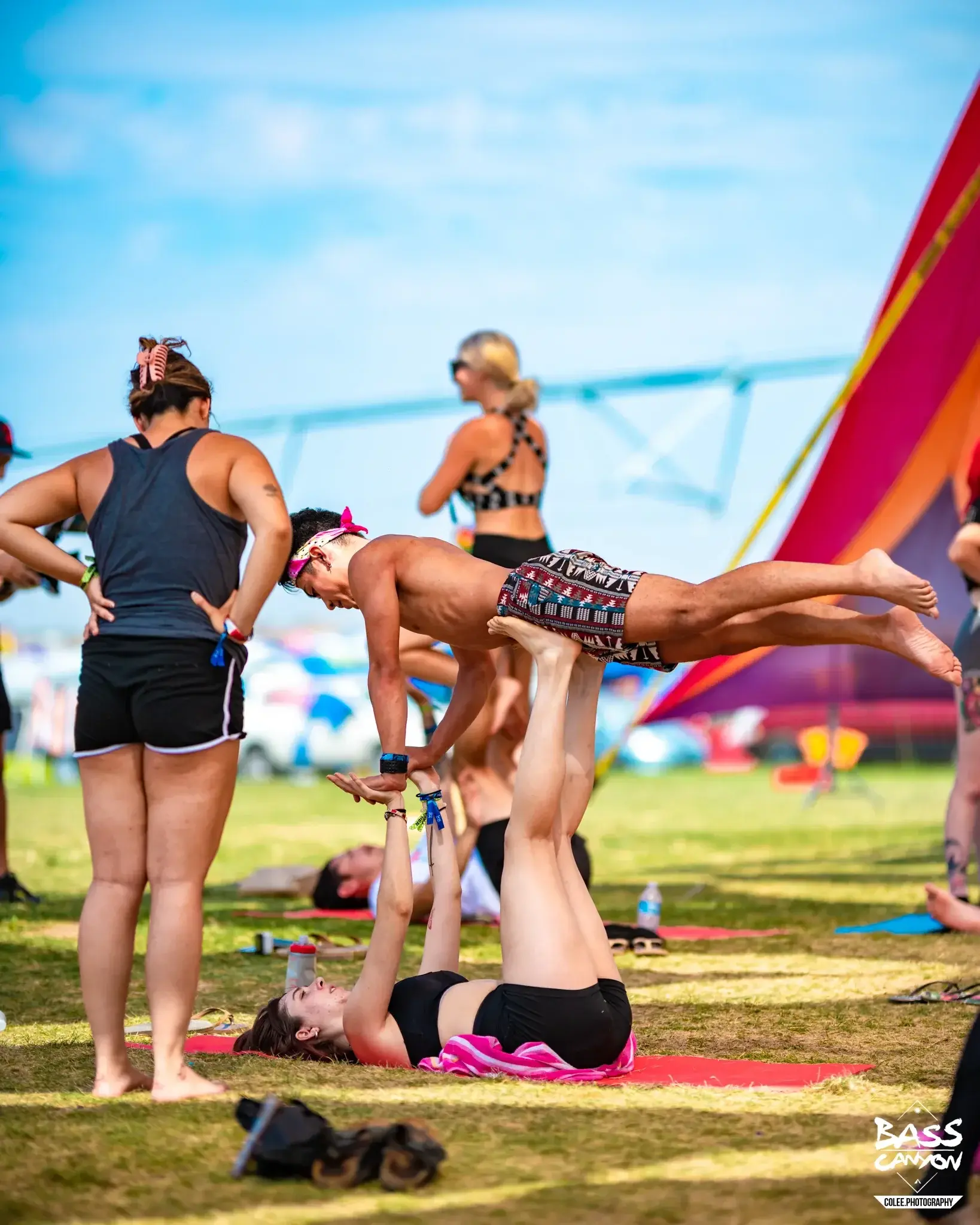 Person balancing face down on a partner's raised feet beside other festivalgoers, Bass Canyon 2022 at The Gorge Amphitheatre, George, Washington