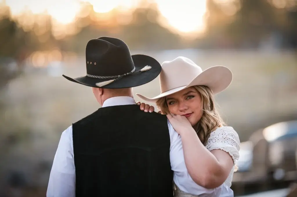 Bride smiling over the groom's shoulder during an outdoor embrace