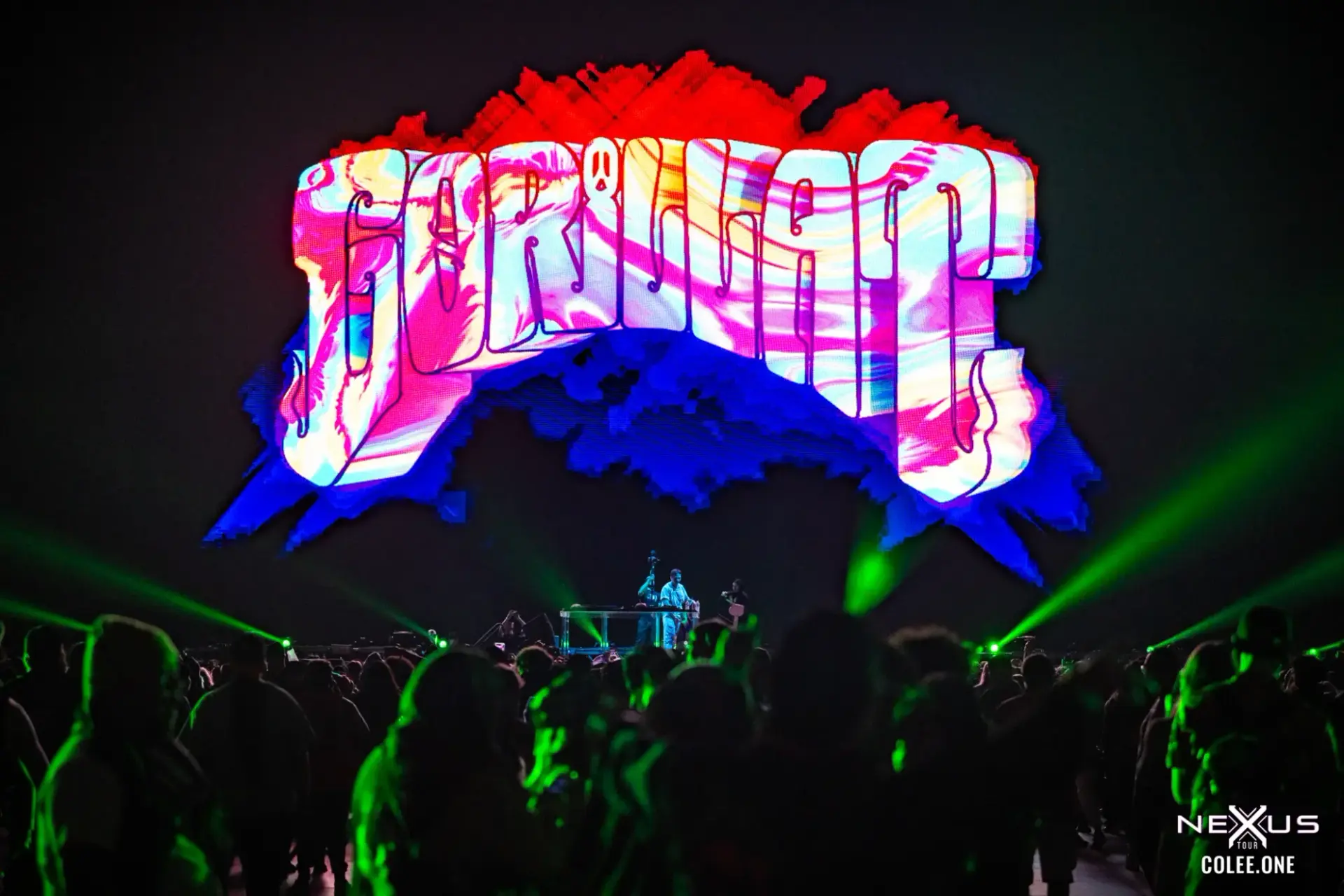Concert audience beneath a colorful stage screen and green lasers, Thunderdome 2024 gallery cover